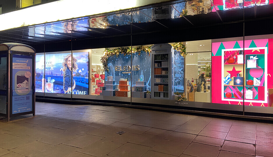 Holiday-themed storefront display featuring Lancôme, Elemis London, and perfume gift boxes at John Lewis.